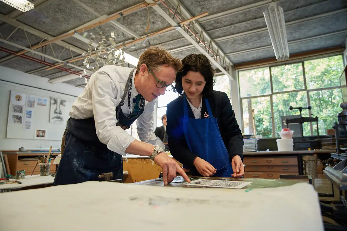 Teacher helping student with design