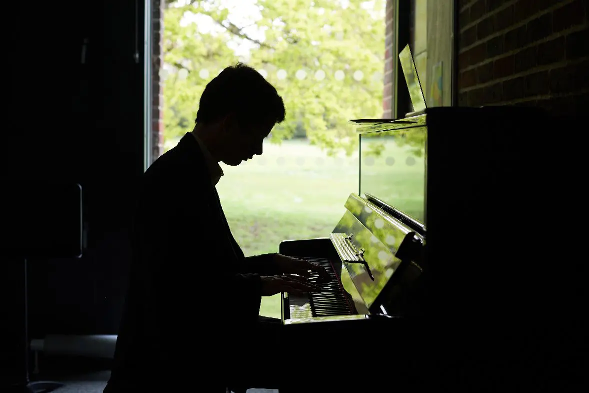 Boy playing at piano