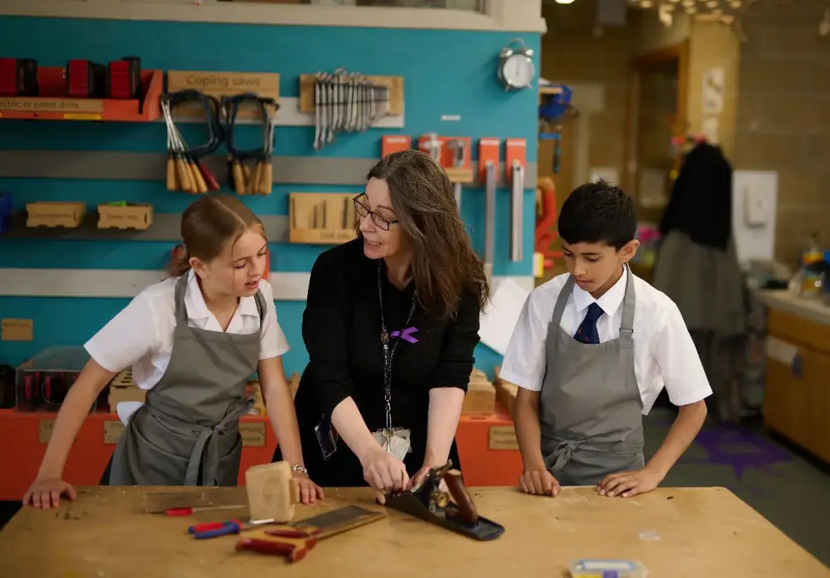 DT teacher with two students