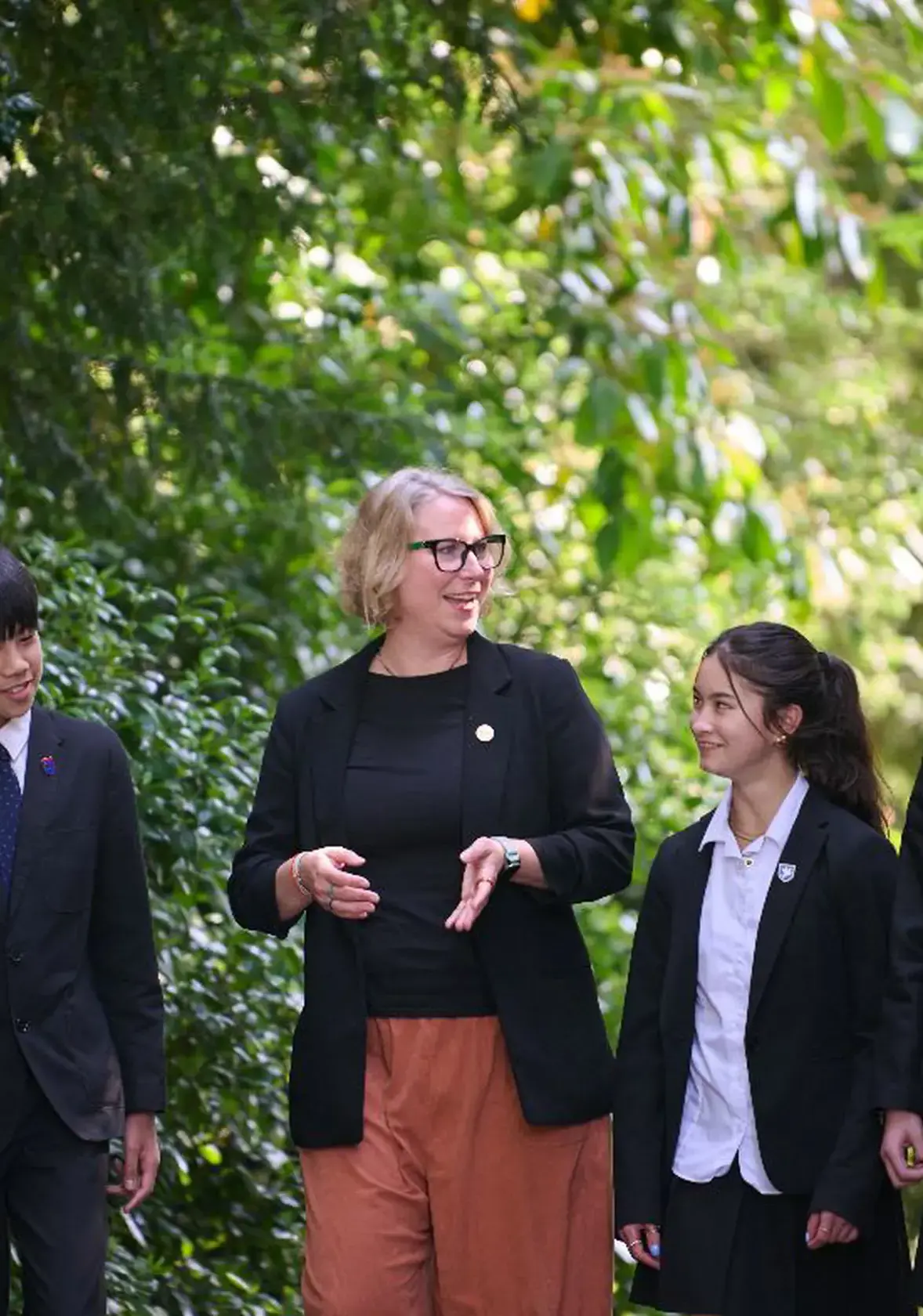 Female teacher walking with students