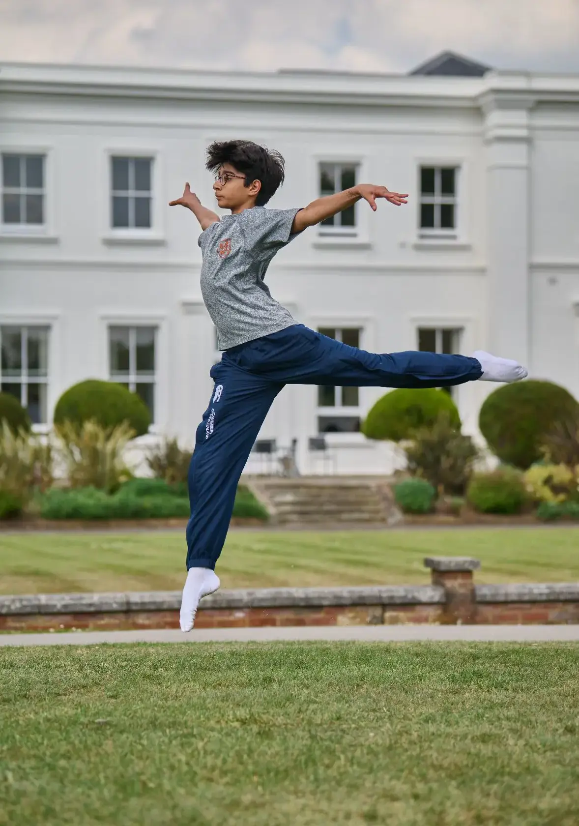 Boy dancing in front of Old School - Leighton Park School