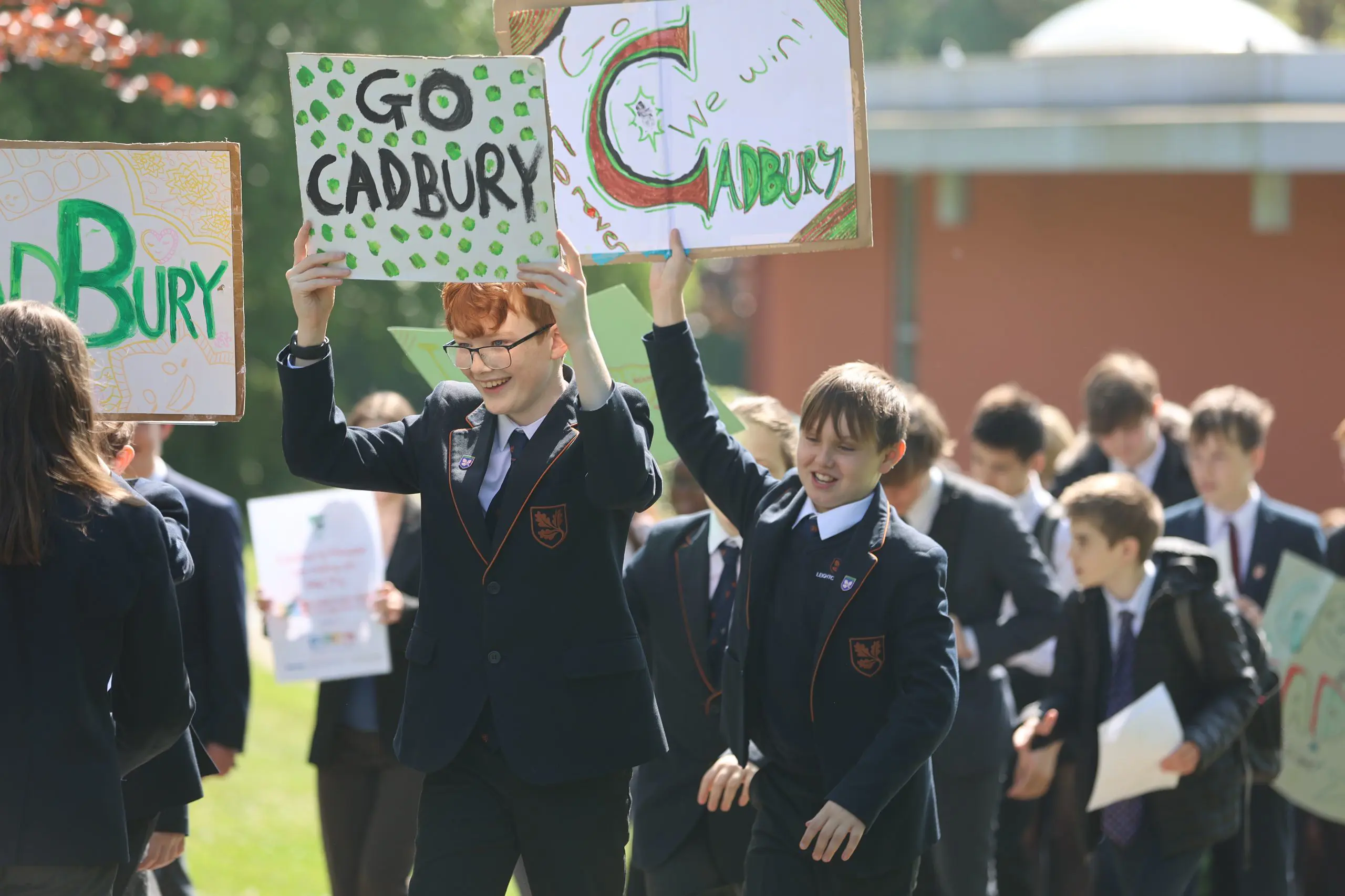 Students holding house signs