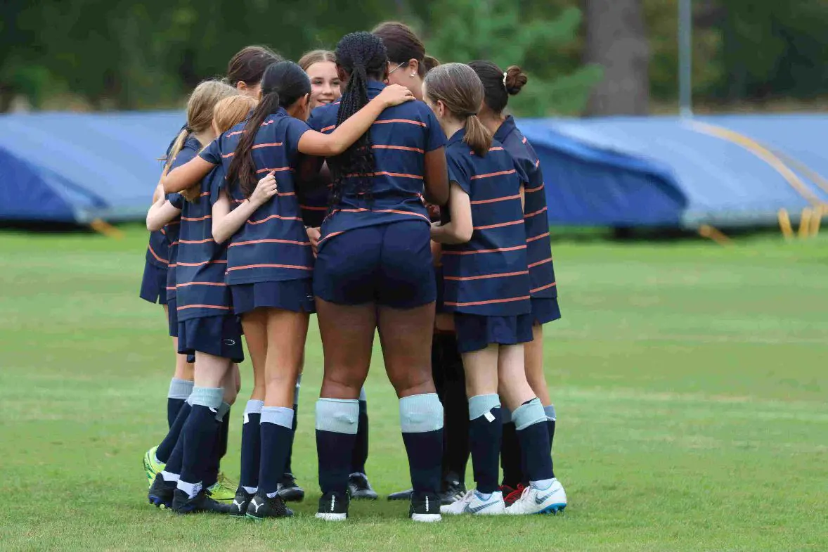 Female football team in huddle