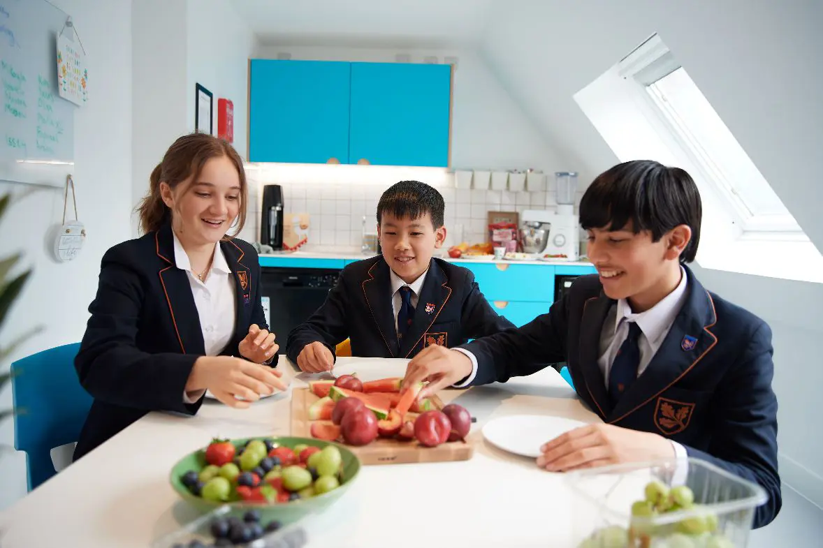 Three students eating at table