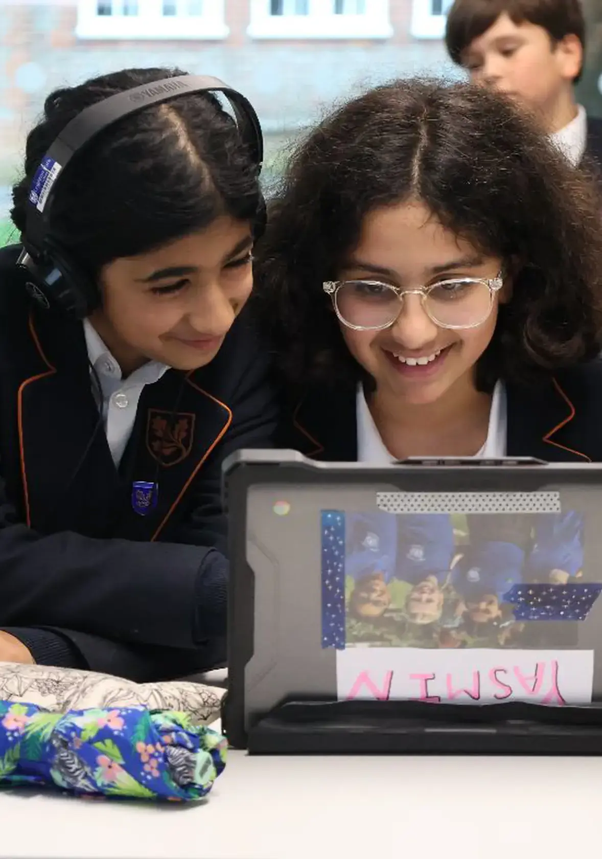 Two girls working together on IT project