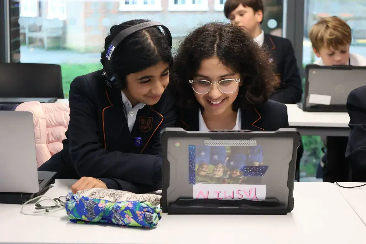 Two girls working together on a technology project